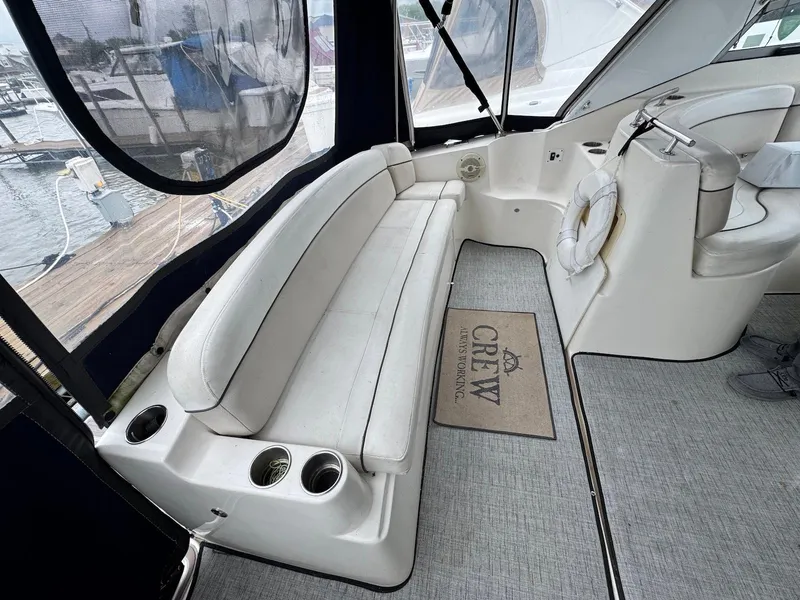 Slide: The Image of 2006 Rinker 342 Express Cruiser interior with white seating and nautical decor. - 5