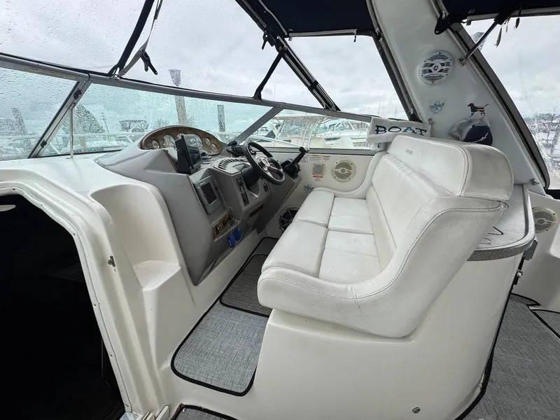 Slide: The Image of 2006 Rinker 342 Express Cruiser cockpit with white seating and control panel. - 6