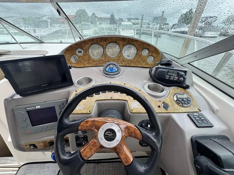 Slide: The Image of 2006 Rinker 342 Express Cruiser helm with steering wheel, gauges, and navigation equipment. - 7