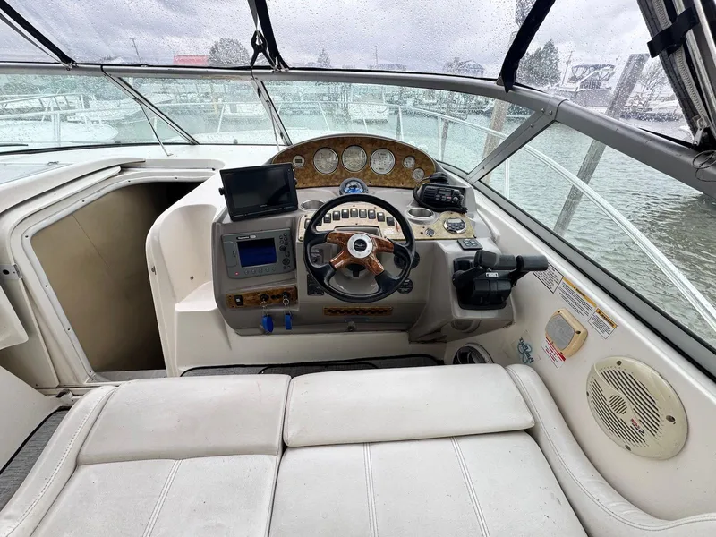 Slide: The Image of 2006 Rinker 342 Express Cruiser helm with steering wheel, gauges, and navigation equipment. - 8