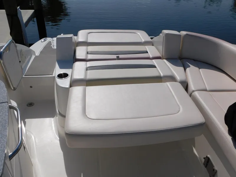 Slide: The Image of 2017 Chaparral 244 Sunesta boat interior with white cushioned seating. - 12
