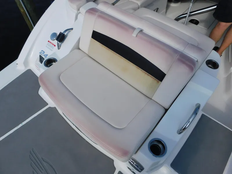 Slide: The Image of 2017 Chaparral 244 Sunesta boat seat with cup holders and control panel. - 13