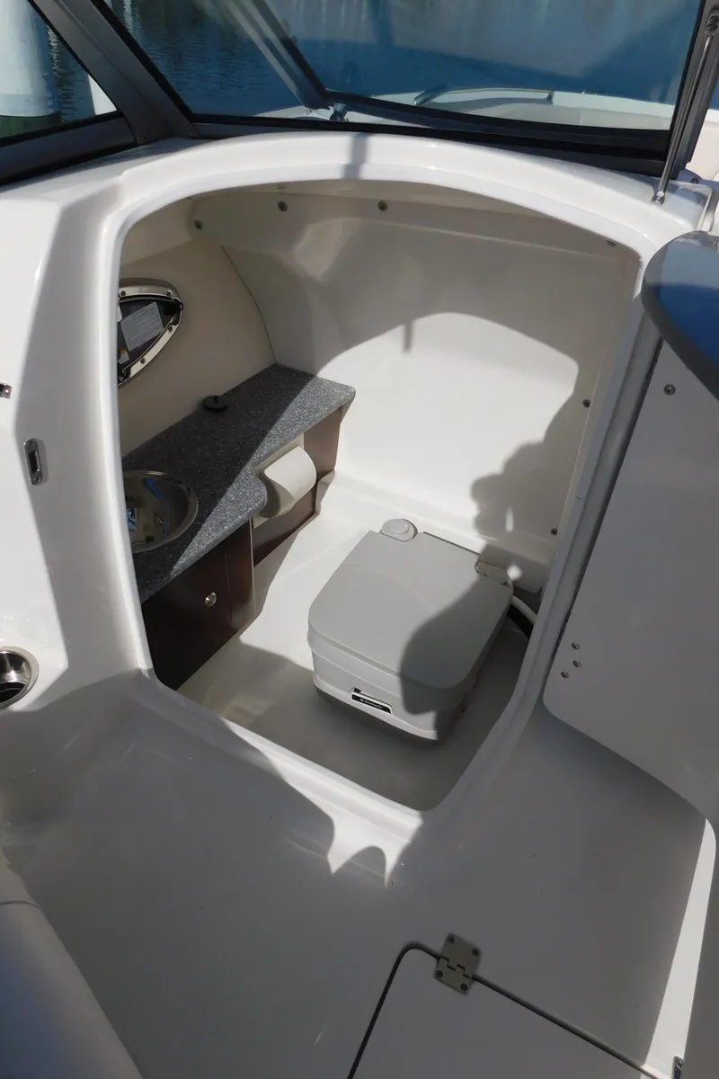 Slide: The Image of 2017 Chaparral 244 Sunesta boat interior with compact cabin and storage. - 15