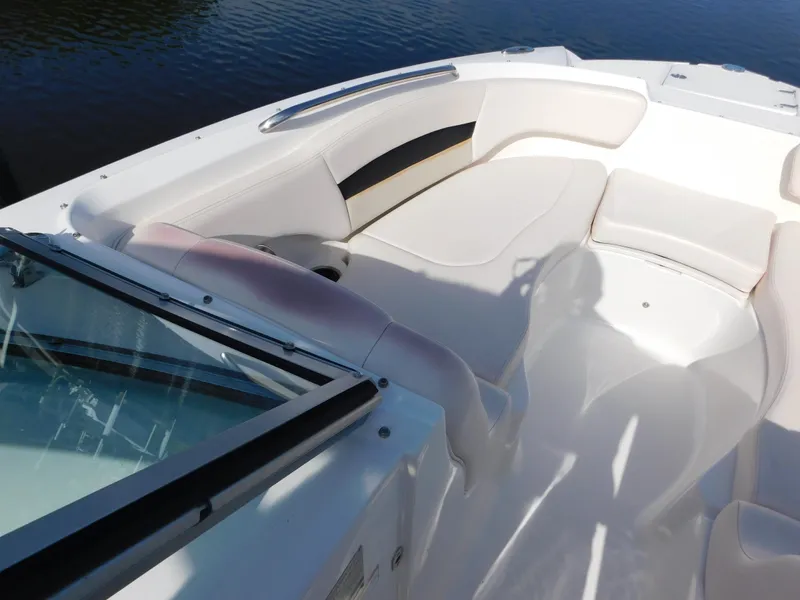 Slide: The Image of 2017 Chaparral 244 Sunesta boat interior with white seating and windshield. - 16