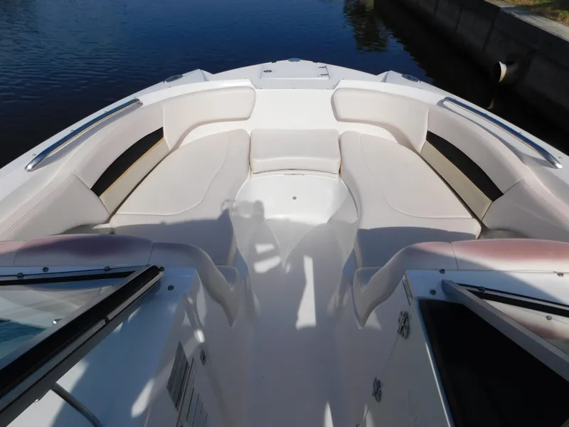 Slide: The Image of 2017 Chaparral 244 Sunesta boat interior with white seating and open bow design. - 17