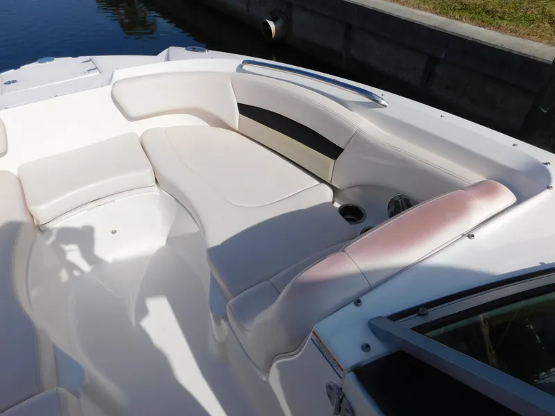 Slide: The Image of 2017 Chaparral 244 Sunesta boat interior with white seating and cup holders. - 18