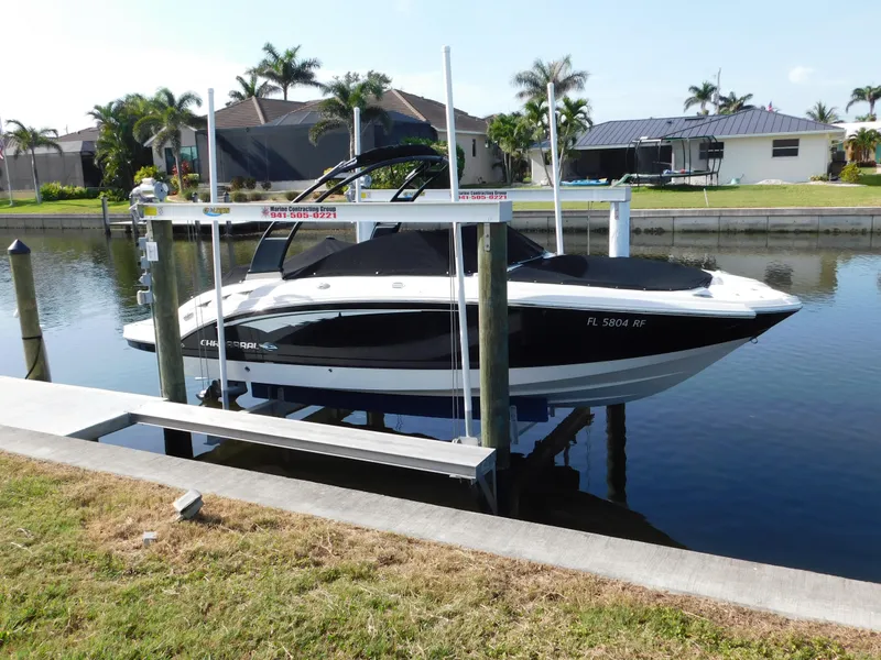 Slide: The Image of 2017 Chaparral 244 Sunesta boat docked on a lift in a canal setting. - 2