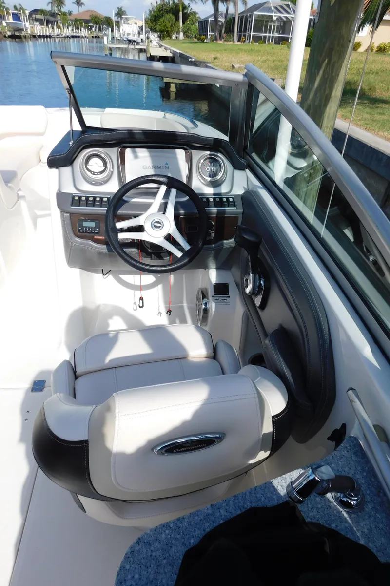 Slide: The Image of 2017 Chaparral 244 Sunesta boat cockpit with steering wheel and dashboard controls. - 6