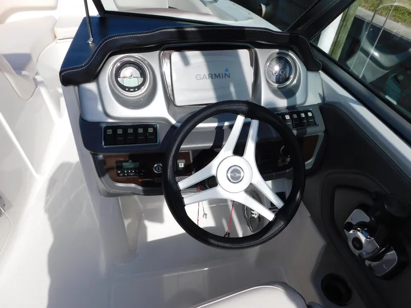 Slide: The Image of 2017 Chaparral 244 Sunesta boat dashboard with Garmin navigation system and steering wheel. - 7