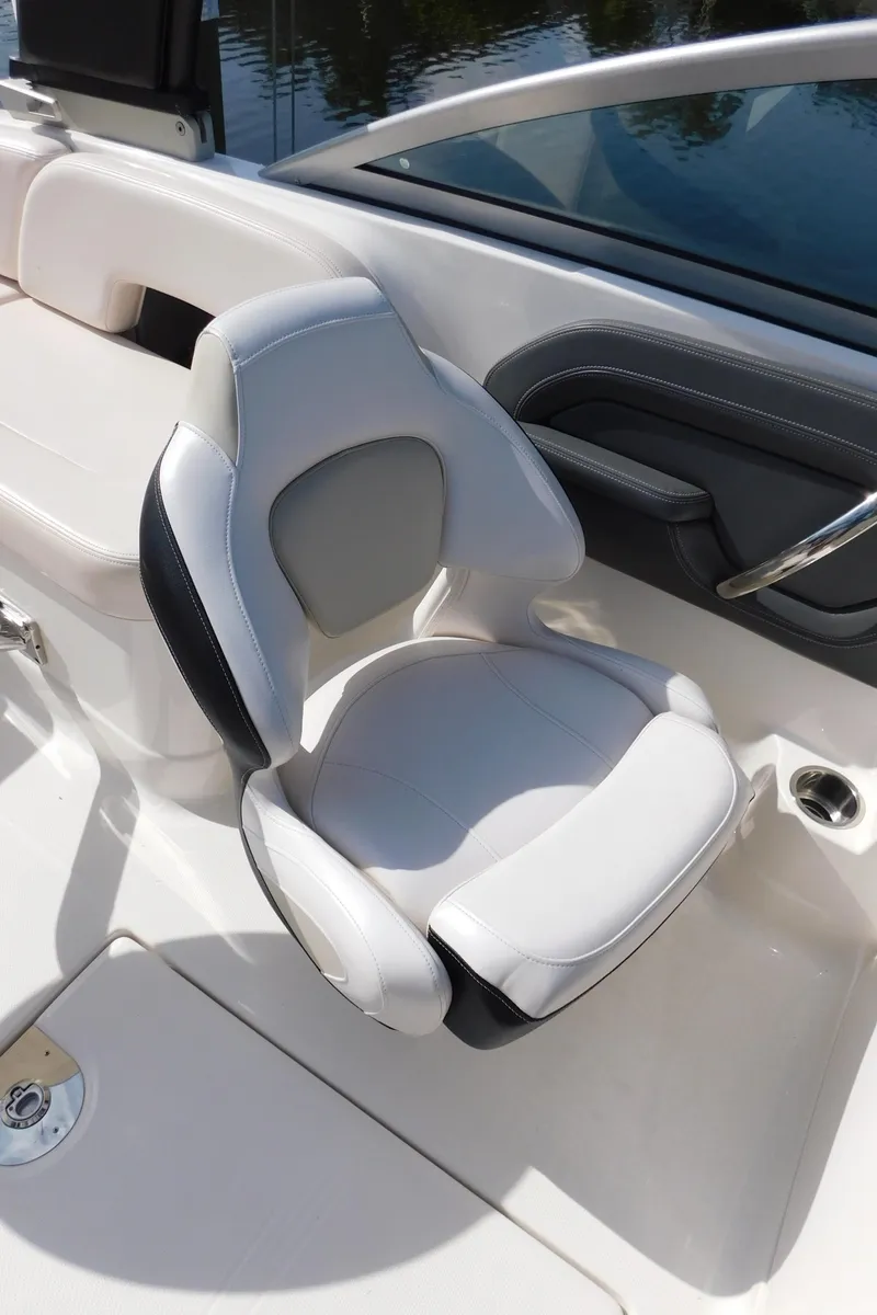 Slide: The Image of 2017 Chaparral 244 Sunesta boat seat, white and gray upholstery, sleek design. - 9