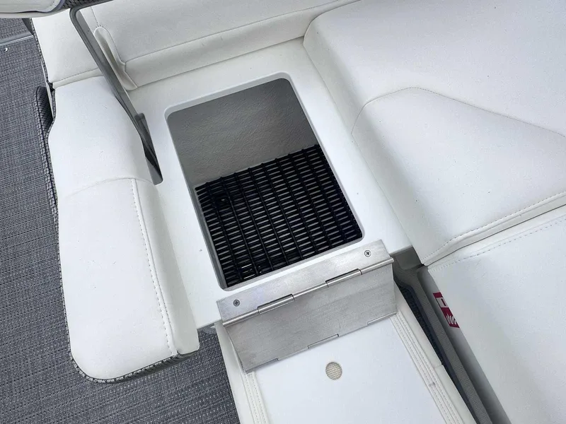 Slide: The Image of 2025 Formula 290 Bowrider interior with white seating and storage compartment. - 11