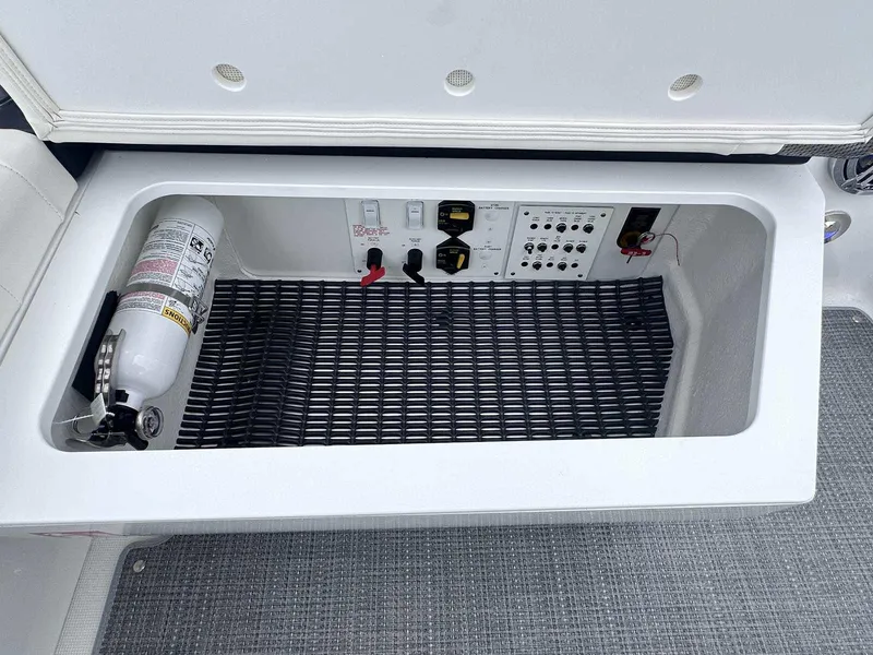 Slide: The Image of 2025 Formula 290 Bowrider storage compartment with fire extinguisher and control panel. - 12