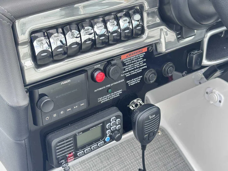 Slide: The Image of Control panel of 2025 Formula 290 Bowrider with switches, radio, and warning labels. - 17