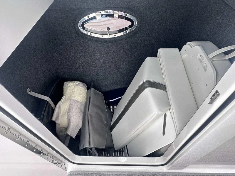 Slide: The Image of Storage compartment in 2025 Formula 290 Bowrider boat, featuring organized interior and porthole window. - 26
