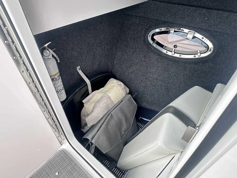 Slide: The Image of Interior of 2025 Formula 290 Bowrider with storage, fire extinguisher, and porthole. - 27
