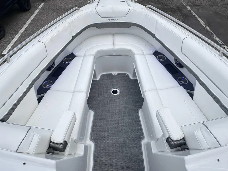 Slide: The Image of 2025 Formula 290 Bowrider boat interior with white seating and gray flooring. - 28