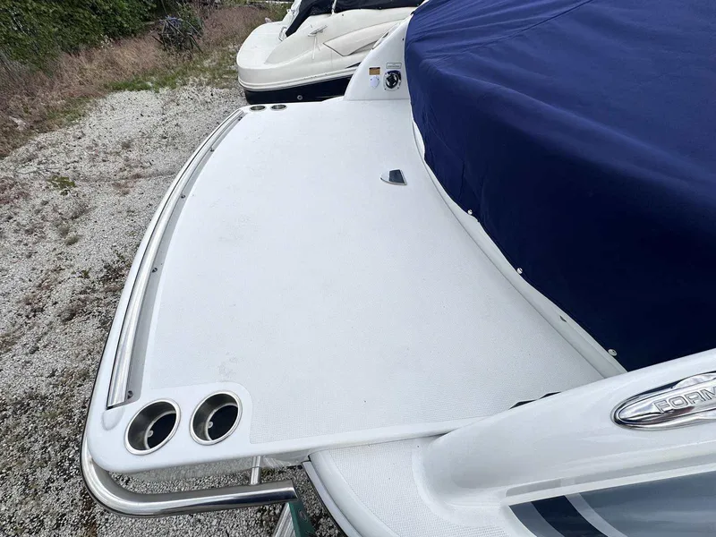 Slide: The Image of 2025 Formula 290 Bowrider boat with covered seating and swim platform. - 3