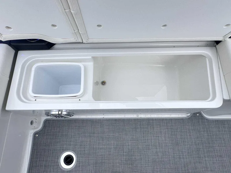Slide: The Image of 2025 Formula 290 Bowrider storage compartment with drain, featuring sleek design and durable materials. - 9