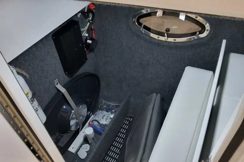 Slide: The Image of Interior storage compartment of 2027 Formula 290 Bowrider boat with equipment and supplies. - 24