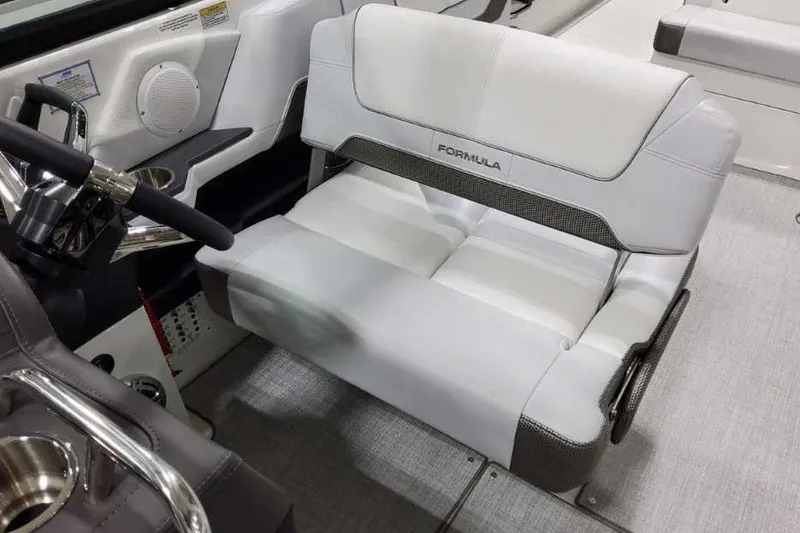 Slide: The Image of 2027 Formula 290 Bowrider interior with sleek white seating and modern steering wheel. - 19