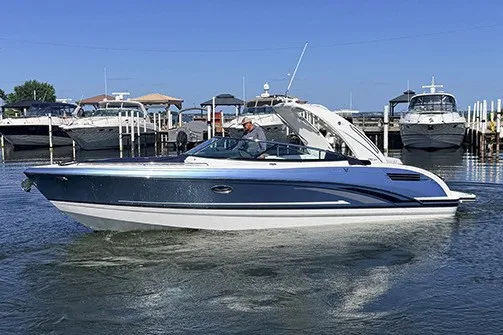 The Image of 2027 Formula 290 Bowrider boat docked in marina, sleek design, blue and white exterior. - 0