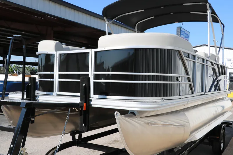 Slide: The Image of 2025 Sylvan Mirage 820 PARTY FISH pontoon boat on trailer, under a canopy. - 6