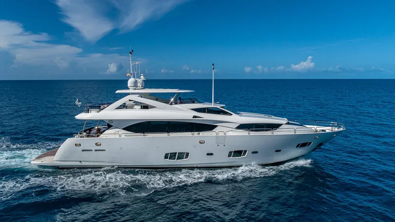 Slide: The Image of 2010 Sunseeker Flybridge yacht cruising on open sea under clear blue sky. - 1