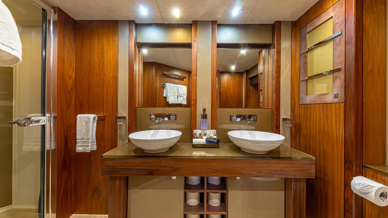 Slide: The Image of Luxurious Sunseeker Flybridge 2010 yacht bathroom with dual sinks and elegant wood finish. - 13