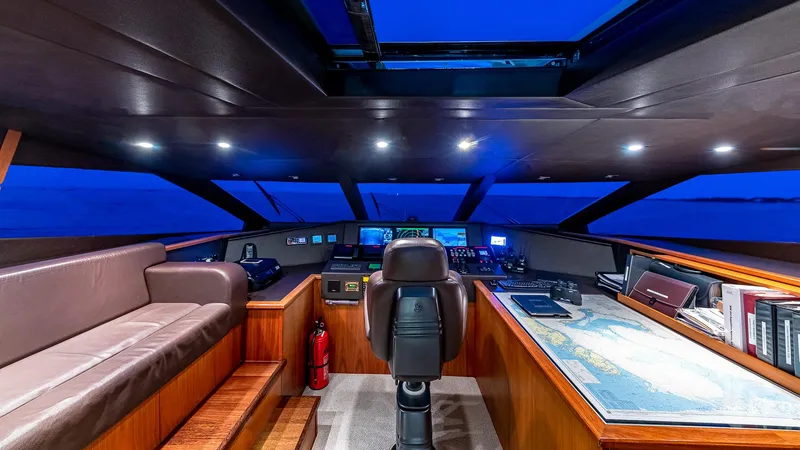 Slide: The Image of Luxurious 2010 Sunseeker Flybridge yacht interior with modern navigation equipment and seating. - 19