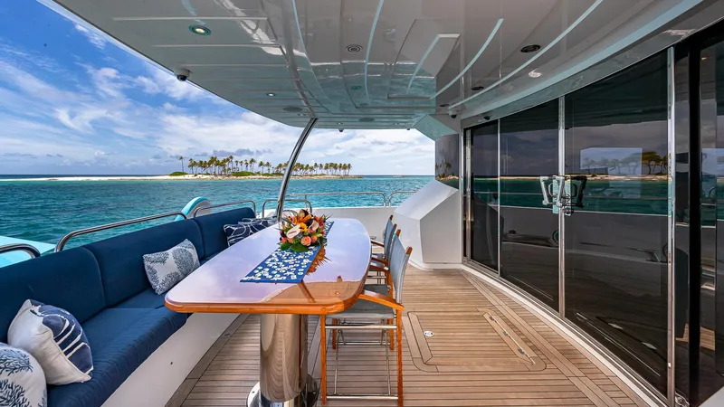 Slide: The Image of Luxurious 2010 Sunseeker Flybridge yacht with elegant deck, ocean view, and island backdrop. - 2