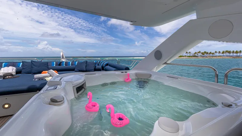 Slide: The Image of Luxurious Sunseeker Flybridge yacht with jacuzzi and ocean view, featuring pink flamingo floats. - 22