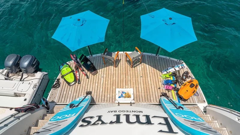 Slide: The Image of Sunseeker Flybridge 2010 yacht deck with water sports gear and blue umbrellas. - 24