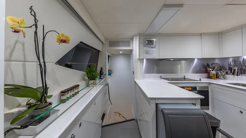 Slide: The Image of Luxurious Sunseeker Flybridge 2010 yacht kitchen with modern white cabinetry and elegant decor. - 7