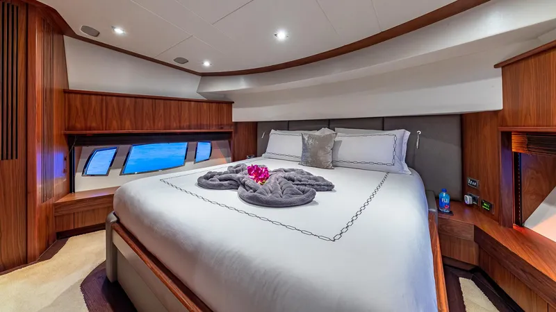 Slide: The Image of Luxurious Sunseeker Flybridge 2010 yacht bedroom with elegant wood finishes and ocean view windows. - 8