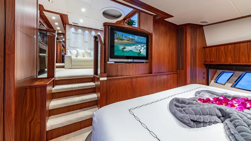 Slide: The Image of Luxurious Sunseeker Flybridge 2010 yacht interior with elegant wood paneling and cozy bedroom. - 9
