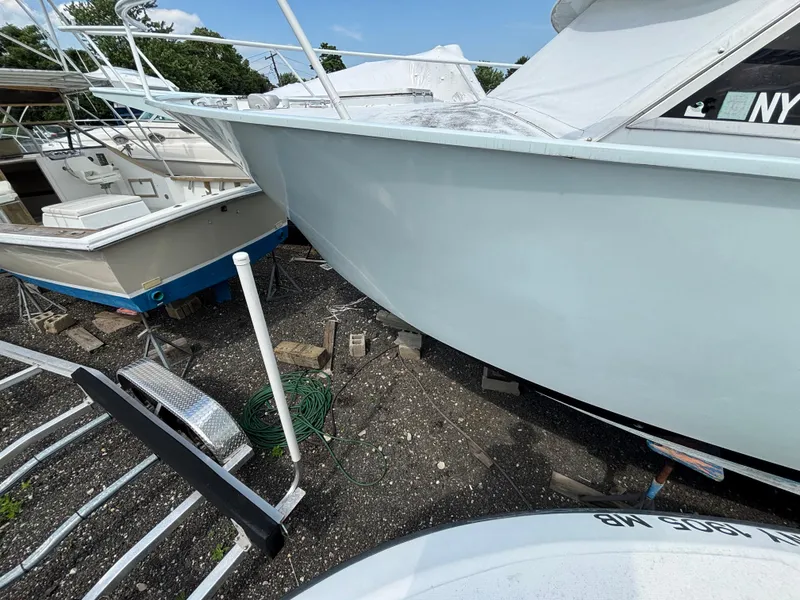 Slide: The Image of 1974 Striker Canyon Runner boat on dry dock, surrounded by other vessels. - 10