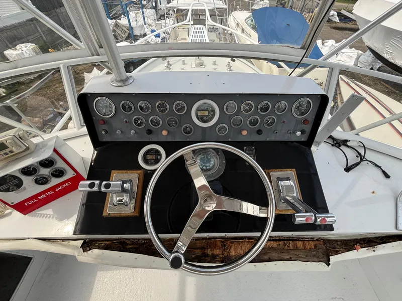 Slide: The Image of 1974 Striker Canyon Runner boat dashboard with steering wheel and gauges. - 12