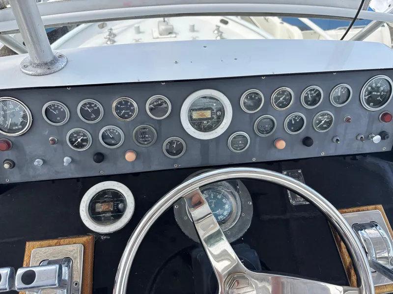 Slide: The Image of 1974 Striker Canyon Runner boat dashboard with gauges and steering wheel. - 13