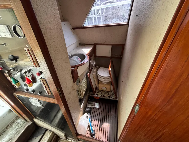 Slide: The Image of 1974 Striker Canyon Runner boat interior with compact bathroom and control panel. - 14