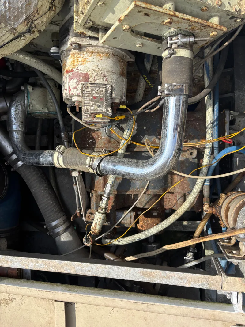 Slide: The Image of Rusty engine components of a 1974 Striker Canyon Runner, featuring pipes and wiring. - 20