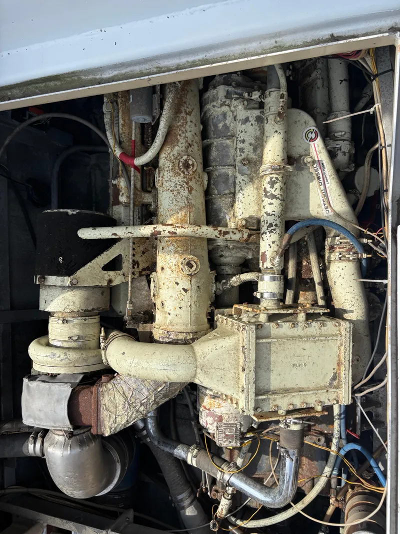 Slide: The Image of 1974 Striker Canyon Runner engine with visible pipes and components, showing signs of wear. - 21