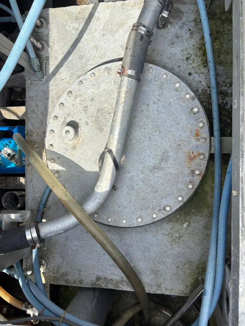 Slide: The Image of Engine compartment of a 1974 Striker Canyon Runner with visible hoses and metal components. - 22