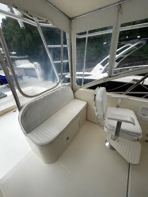 Slide: The Image of 2005 Carolina Classic 28 Express boat interior with seating and helm. - 12