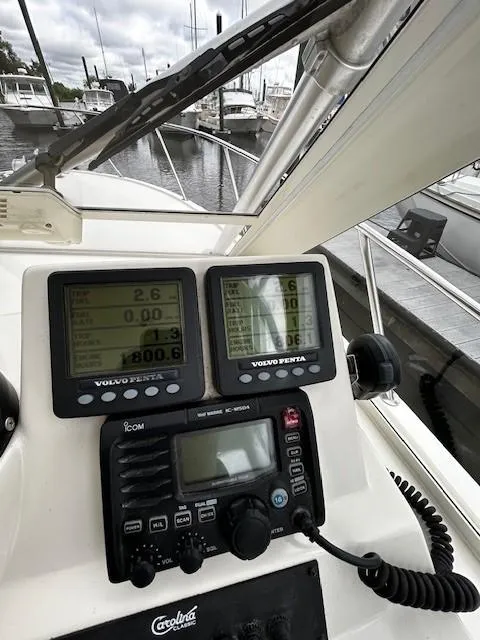 Slide: The Image of 2005 Carolina Classic 28 Express boat dashboard with navigation and communication equipment. - 13