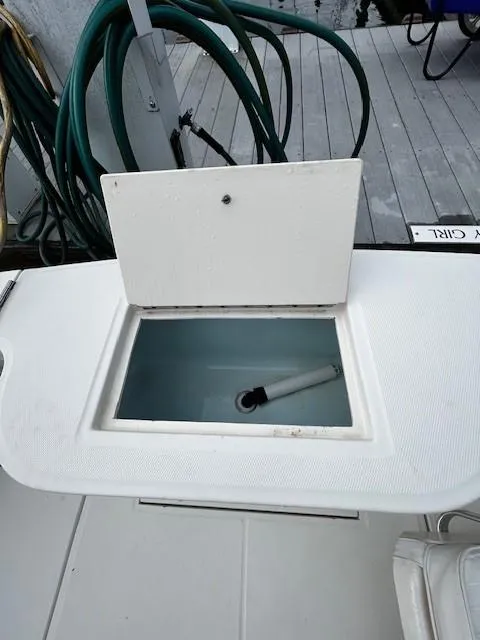 Slide: The Image of 2005 Carolina Classic 28 Express boat deck with open storage compartment. - 14