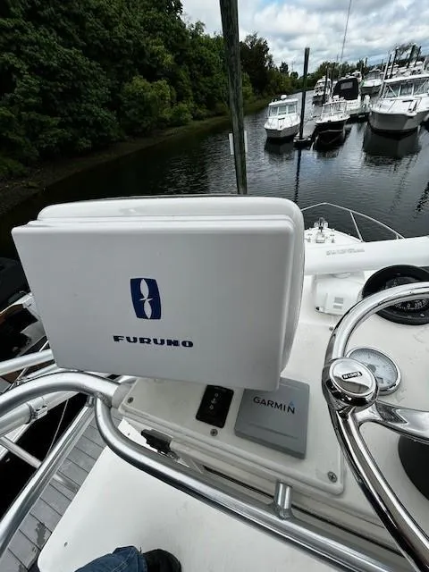 Slide: The Image of 2005 Carolina Classic 28 Express boat helm with Furuno and Garmin navigation systems. - 19