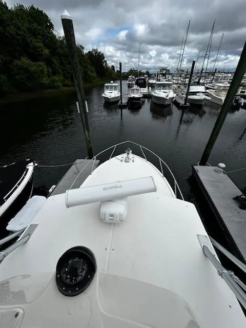 Slide: The Image of 2005 Carolina Classic 28 Express boat docked in a marina, surrounded by other vessels. - 21