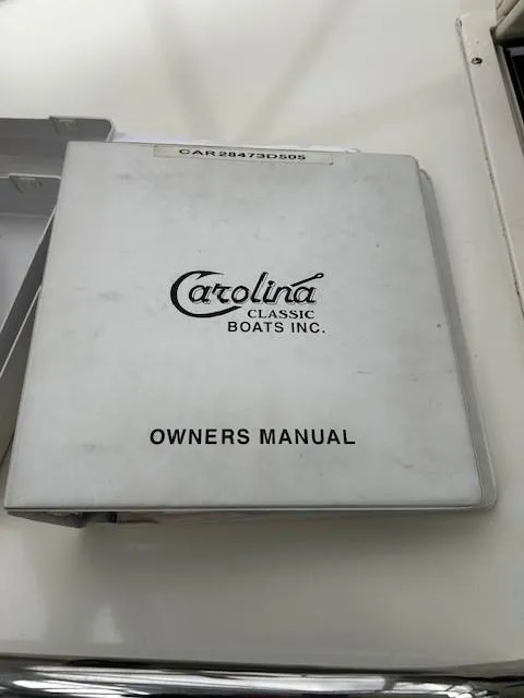 Slide: The Image of 2005 Carolina Classic 28 Express owner's manual on a white surface. - 26