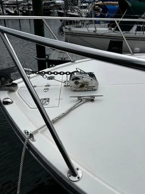 Slide: The Image of 2005 Carolina Classic 28 Express boat deck with anchor chain and railing. - 27