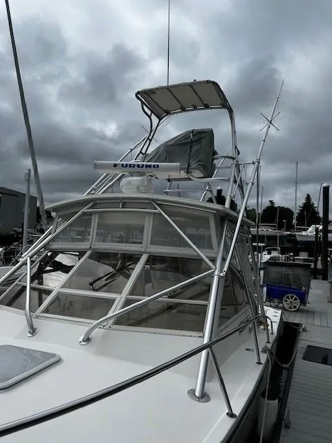Slide: The Image of 2005 Carolina Classic 28 Express boat docked under cloudy skies. - 3